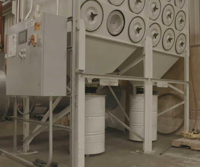 Dynamo dust collector system installed in an industrial facility.