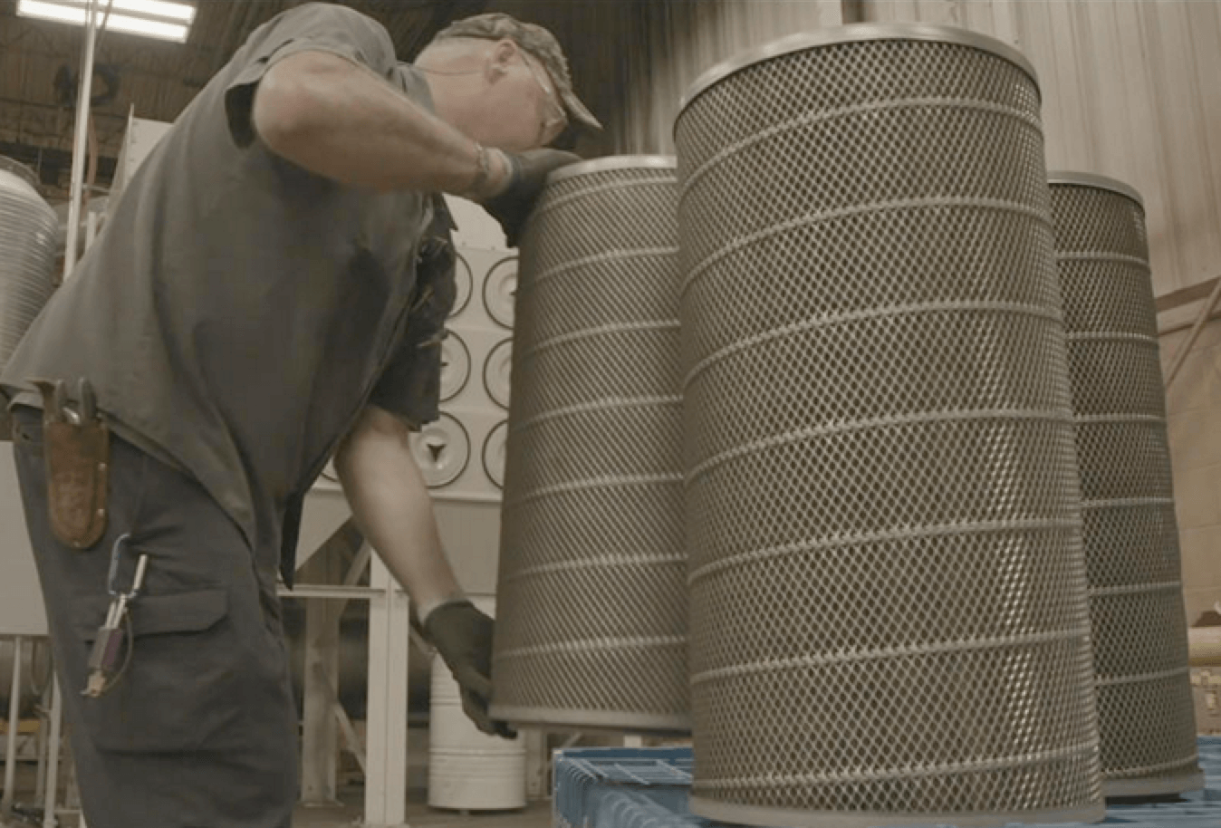 Machine operator changing out the dust collector cartridge filters.