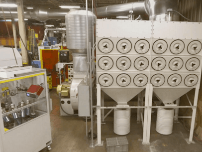 A central dust collector and dust ducting system shown installed in an industrial facility.