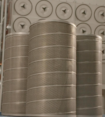 Dust collector replacement filters displayed in front of an industrial dust collector.