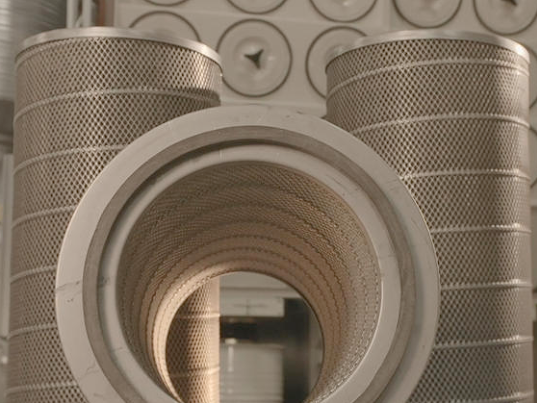 Dust collector cartridge filters placed in front of a central dust collector.